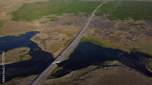 Iceland Drone Shots - 4K. Road 427. Bridge over Hlidarvatn near Reykjanesfolkvangur. Following vehicles crossing bridge. photo