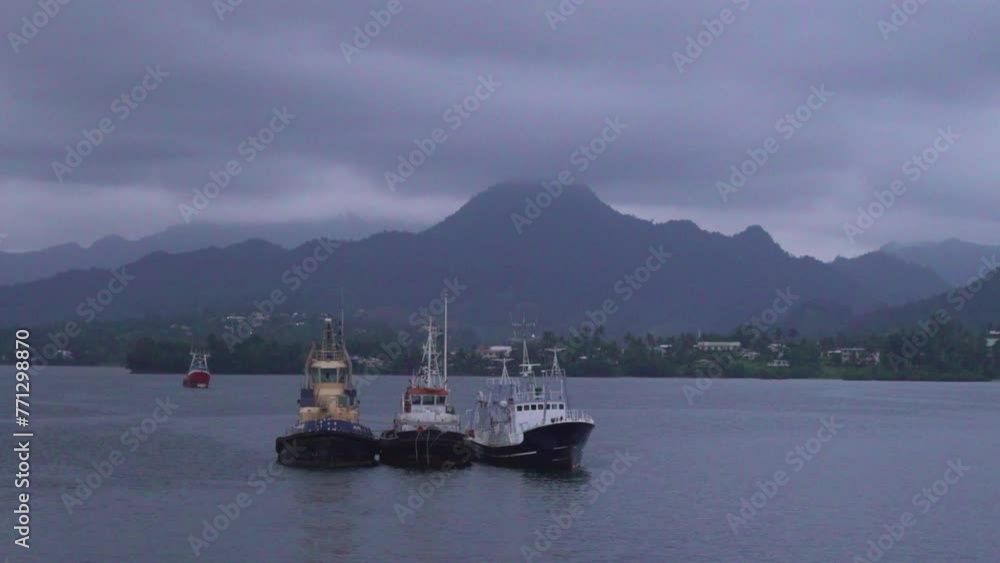 Rainy cloudy fishing boats cruise Fiji Fijian sea port marina Garden Island Taveuni Island Suva Nadi Pacific Ocean shoreline beach front jungle rainforest on hillside Viti Levu Group landscape nature Rainy cloudy fishing boats cruise Fiji Fijian sea port marina Garden Island Taveuni Island Suva Nadi Pacific Ocean shoreline beach front jungle rainforest on hillside Viti Levu Group landscape nature