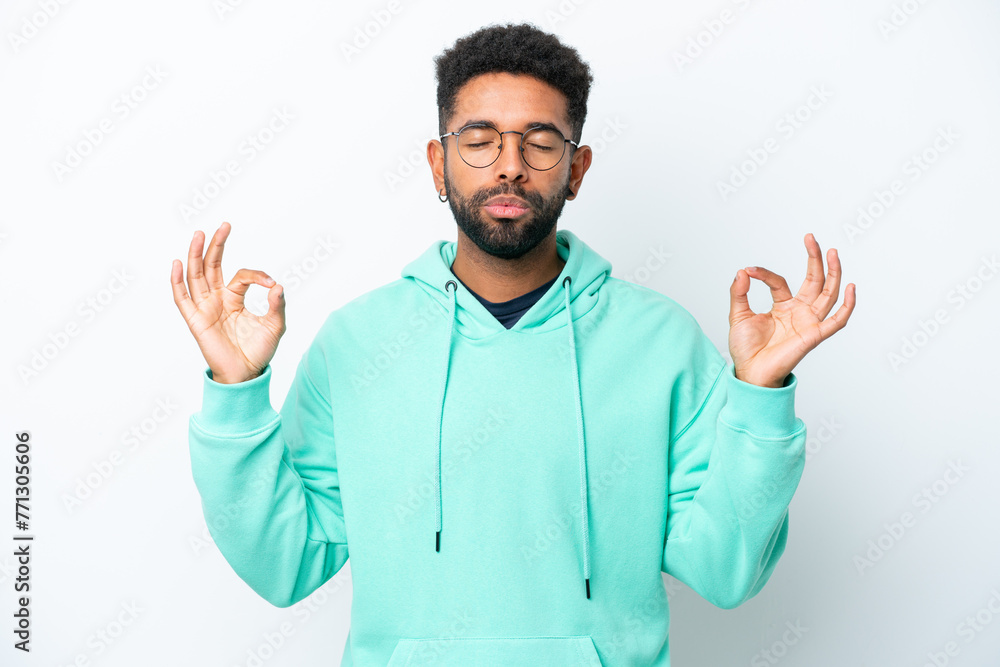 Young Brazilian man isolated on white background in zen pose Young Brazilian man isolated on white background in zen pose