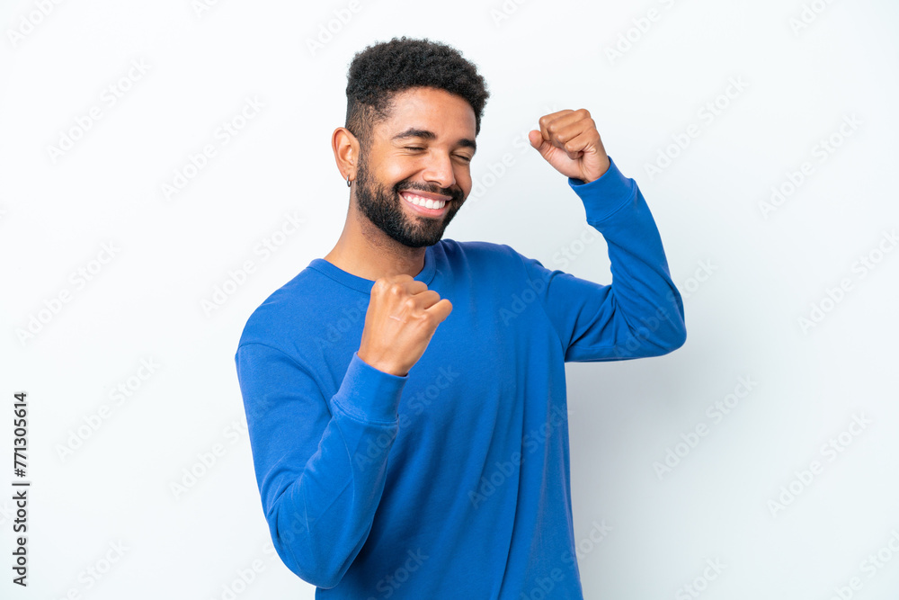 Young Brazilian man isolated on white background celebrating a victory Young Brazilian man isolated on white background celebrating a victory
