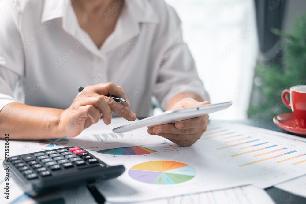 Businesswoman working on desk office with using a calculator to calculate the numbers, finance accounting concept. Woman accountant use calculator and computer. tax, accounting, statistics Businesswoman working on desk office with using a calculator to calculate the numbers, finance accounting concept. Woman accountant use calculator and computer. tax, accounting, statistics