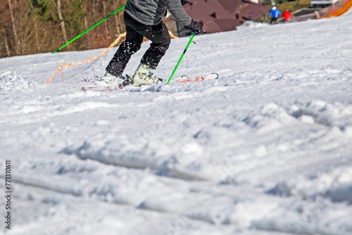 skier starts carving down the mountain on a sunny day. Active family vacation