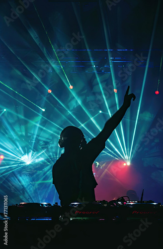 A photo of the silhouette of an arm raised DJ with laser lights shining on them, night club vibes, pink and blue lighting