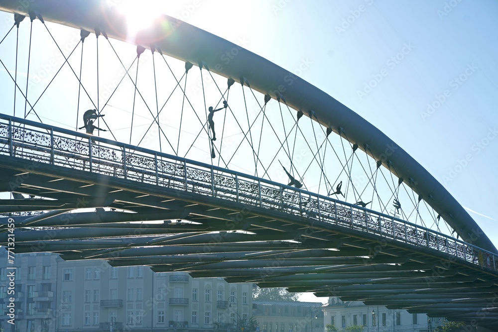 Fototapeta premium Poland. Krakow. Artistic Bridge with Sculpted Figures in the Sunlight. J zef Pi sudski Bridge. Bridge Circus