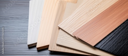 Various types of timber are neatly stacked together in a close arrangement, showcasing a range of wood materials for design and construction purposes