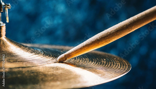 Macro Shot of Drumstick on Shiny Cymbal with Deep Blue Background