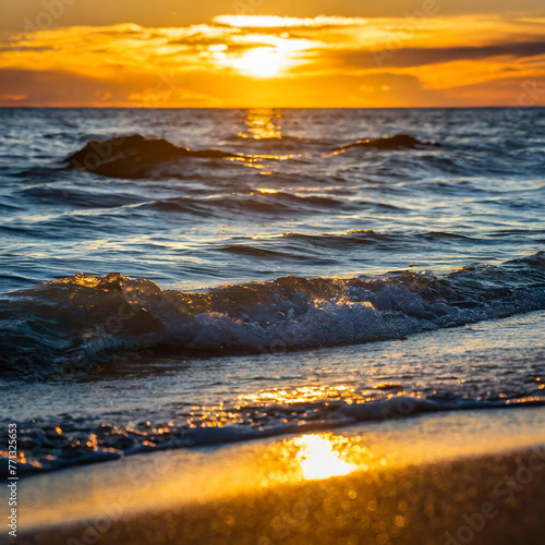 The shimmering waves reflect the warm hues of the setting sun creating a tranquil and breathtaking scene.