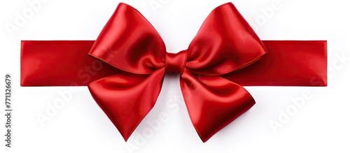 A detailed close-up view of a vibrant red satin gift bow  isolated against a clean white background.