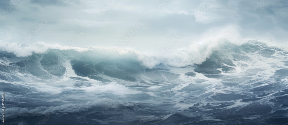 Majestic large wave forming in the ocean under a clear sky backdrop, creating a picturesque scene