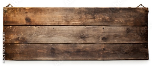 A weathered wooden sign, is...