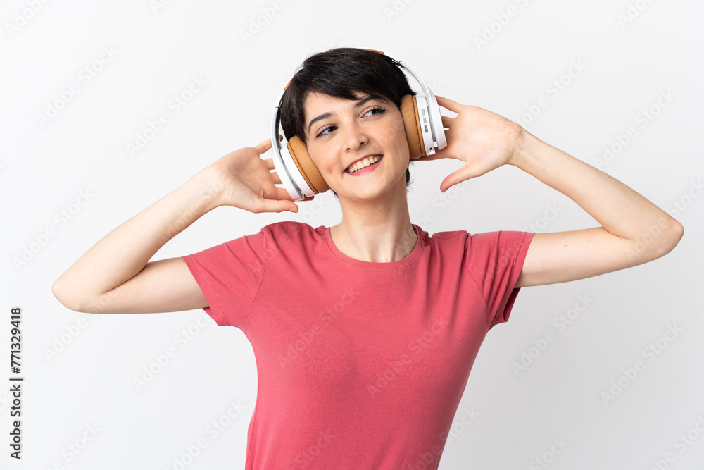 Woman with short hair isolated on white background listening music Woman with short hair isolated on white background listening music