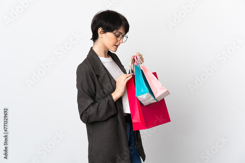 Woman with short hair isolated on white background holding shopping bags