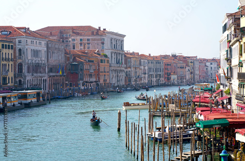Venice, Italy - September 2023: Ferries and gondolas sail along the Grand Canal of Venice at sunset on a warm day