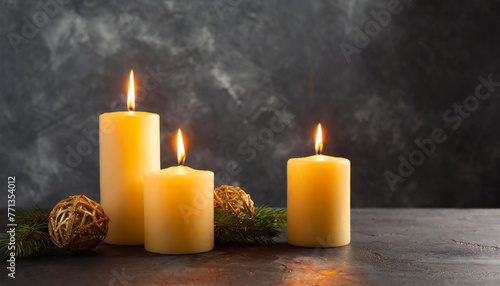 Burning candles on dark background. front view.