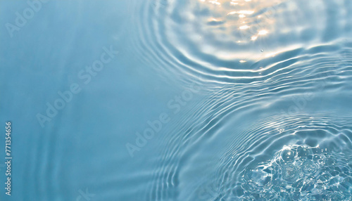 Transparent blue clear water surface texture with ripples, splashes and bubbles. Abstract summer banner background Water waves in sunlight with copy space