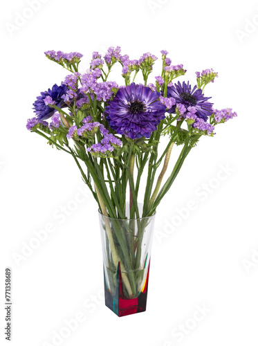 bouquet of blue flowers of statice and anemone of blue terry in a glass vase on a white background isolated