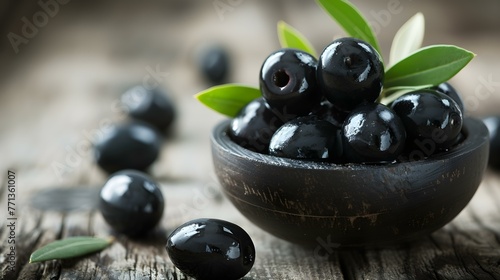 Close up of fresh Black Olives on a rustic wooden Table photo