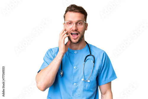 Young nurse man over isolated chroma key background with surprise and shocked facial expression