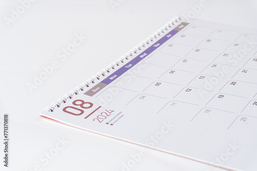 side view of a clean paper calendar on white background. August page of 2024 desk calendar.  