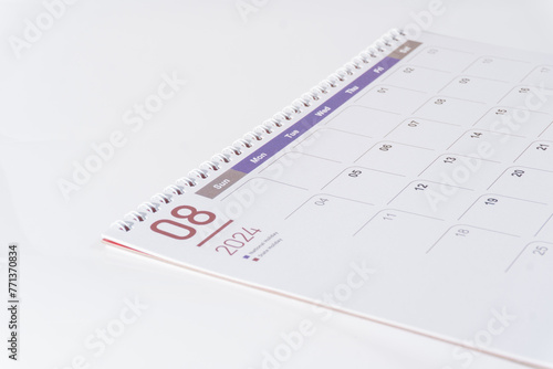 side view of a clean paper calendar on white background. August page of 2024 desk calendar. 