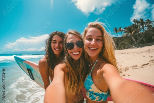 Happy surfing friends are taking selfie in sea with blue blurry sea in backdrop