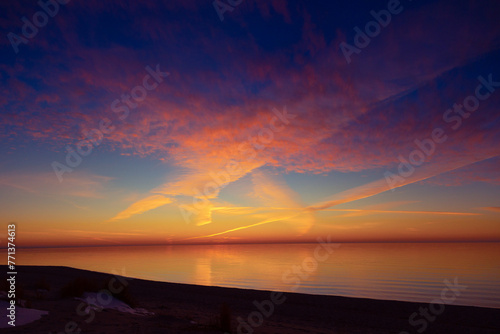 A beautiful minimalist scenery of a sunset at the Baltic sea. Colorful beach landscape of Northern Europe.