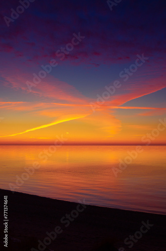 A beautiful minimalist scenery of a sunset at the Baltic sea. Colorful beach landscape of Northern Europe.