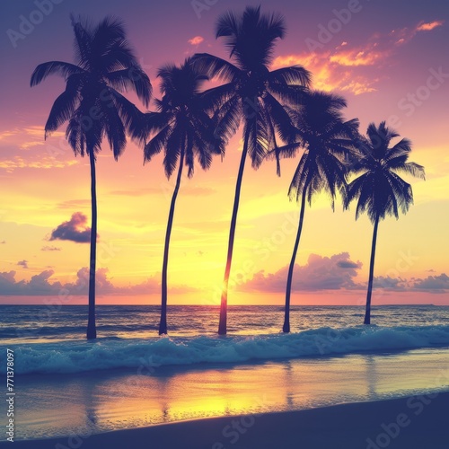 Palm trees on a tropical beach with a setting sun © Adobe Contributor