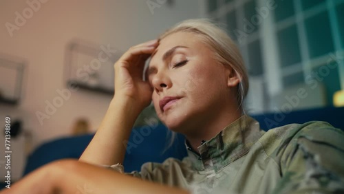 Stressed female soldier suffering from posttraumatic stress disorder, trauma photo