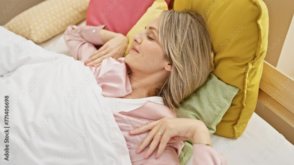 Caucasian woman relaxing in a colorful bedroom with pillows and a cozy atmosphere Caucasian woman relaxing in a colorful bedroom with pillows and a cozy atmosphere