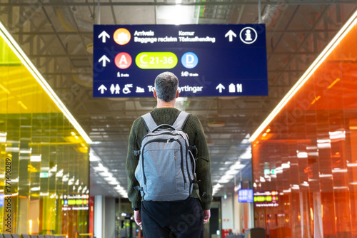 Traveler man looking at a sign in an airport
