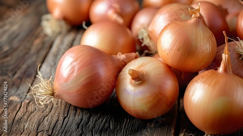 Close up of fresh White Onions on a rustic wooden Table