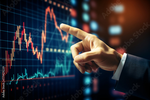 hand of businessman pointing at stock price graph