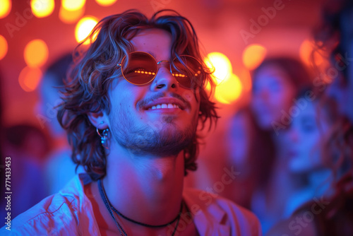Happy handsome young man dancing at a nightclub party, disco guy having fun at a music festival © staras