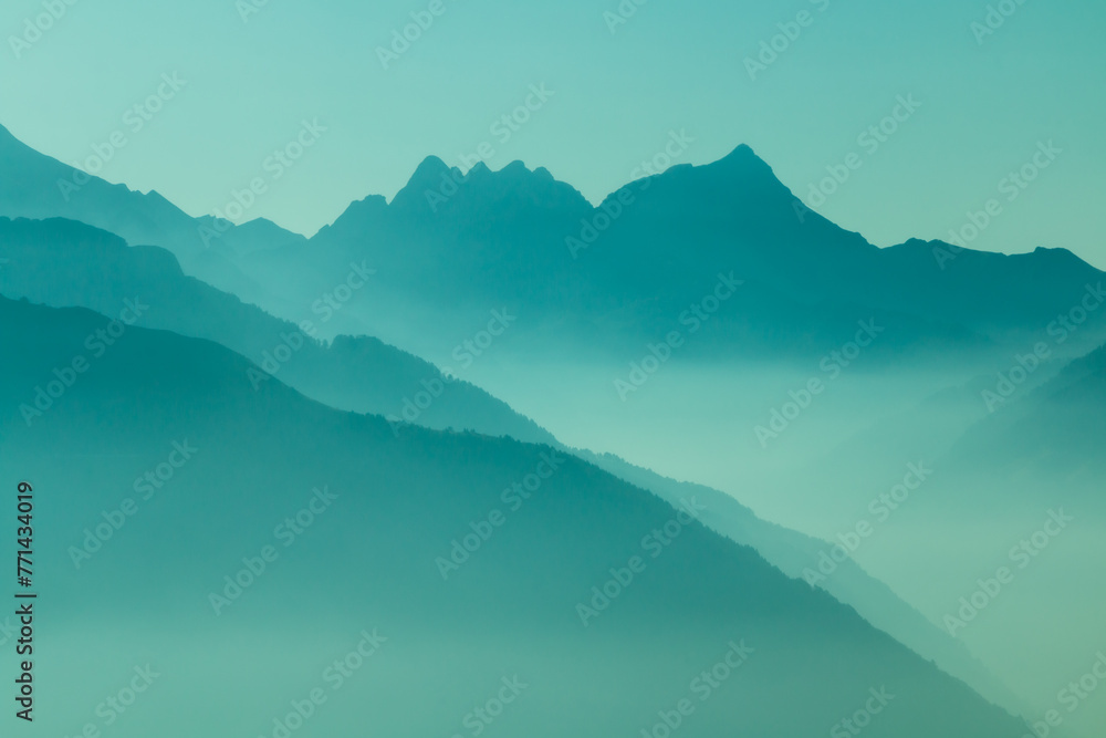 Spectacular mountain ranges silhouettes in shades of blue.