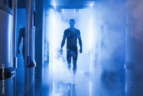 A sci-fi scene with a silhouette of a male figure emerging from a cylindrical cryotherapy chamber surrounded by fog, evoking a sense of advanced technology