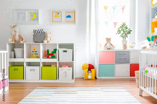 White nursery room with shelves and colourful boxes. © Tjeerd