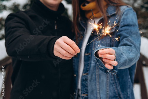 couple holding sparklers in hands