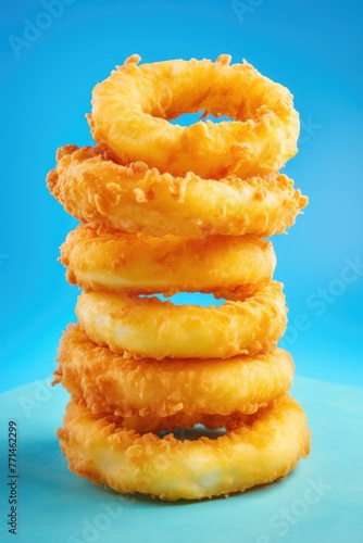 Onion rings on blue background. Highly detailed close up image. © Twomeows_AS