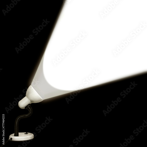 Table lamp shines white light on a black background