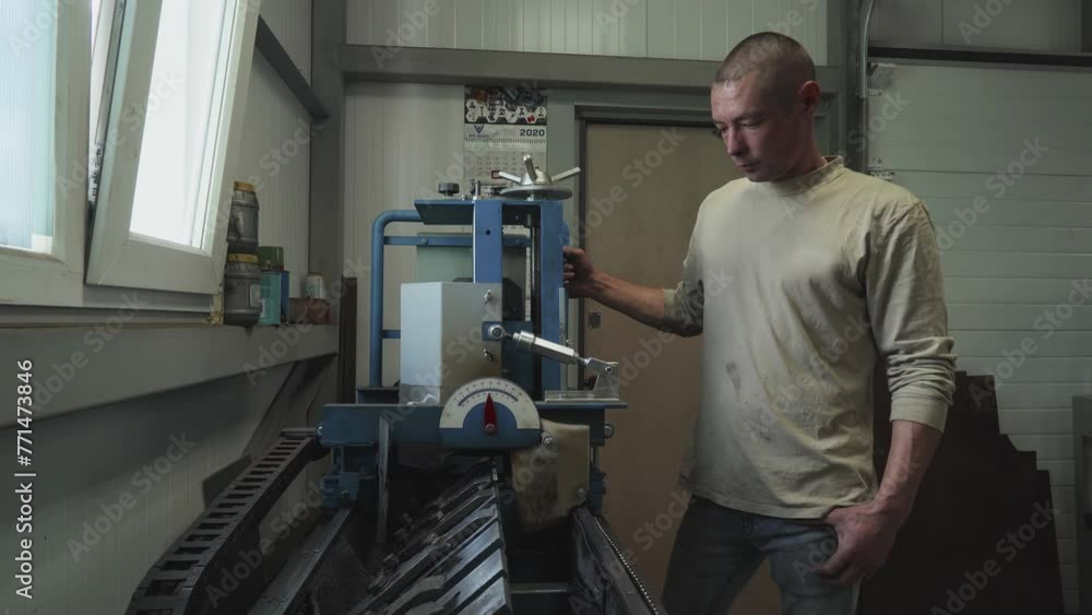 Laborer is operating the industrial machine for saw blades sharpening. Moving the industrial grinding equipment to sharpen the saw blades. Worker is sharpening the saw blades using industrial machine. Laborer is operating the industrial machine for saw blades sharpening. Moving the industrial grinding equipment to sharpen the saw blades. Worker is sharpening the saw blades using industrial machine.