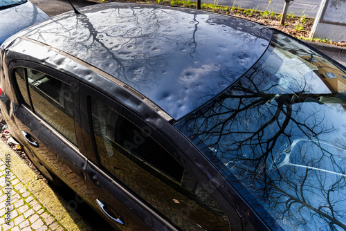 detail of the roof of the car damaged by hail. damage from natural disaster. hail damage