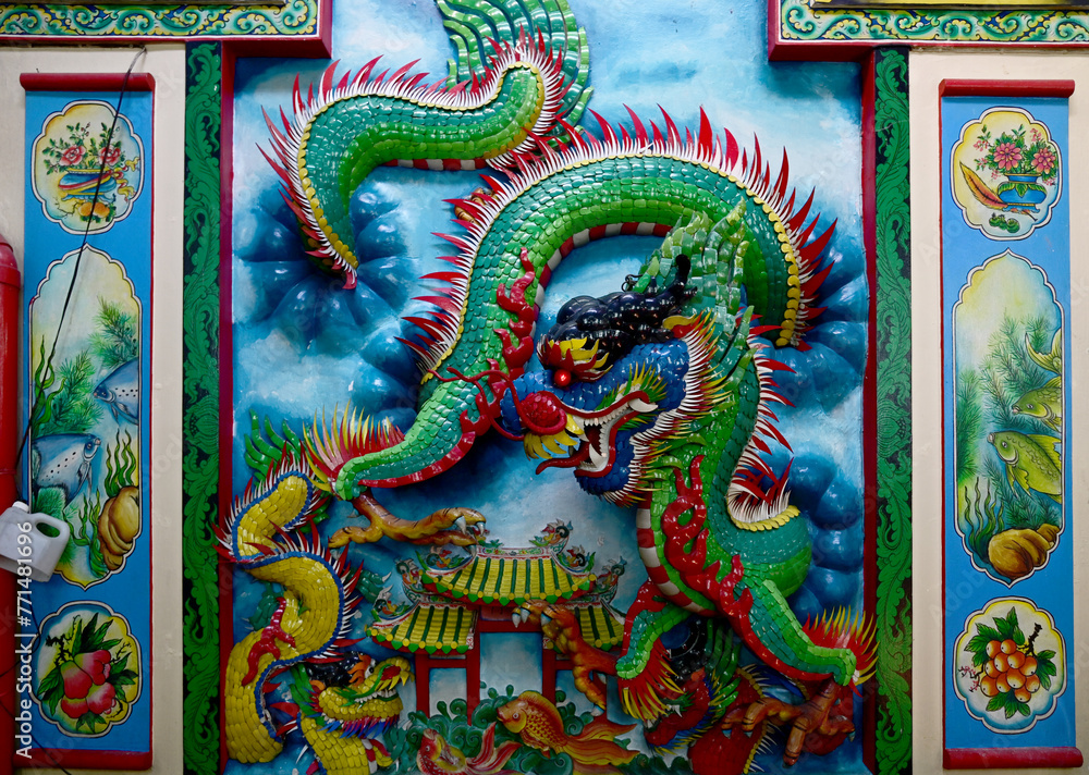 BANGKOK, THAILAND - March 31, 2024: The Colorful Dragon decoration on the wall background in Chow Sue Kong shrine is a Chinese shrine that is often visited by the local community to pray for blessings