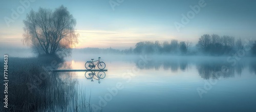 Long distance shot of riding a bicycle on a plank walking along the lake photo