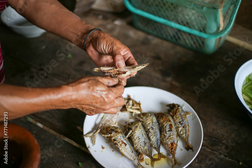 Selective focus Many fried mackerel are about to be eaten. Hilltribe forest people in Thailand