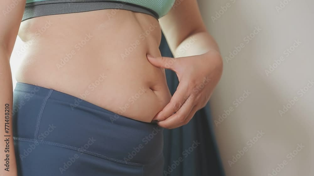 Women body fat belly. Obese woman hand holding excessive belly fat. diet lifestyle concept to reduce belly and shape up healthy stomach muscle. Women body fat belly. Obese woman hand holding excessive belly fat. diet lifestyle concept to reduce belly and shape up healthy stomach muscle.