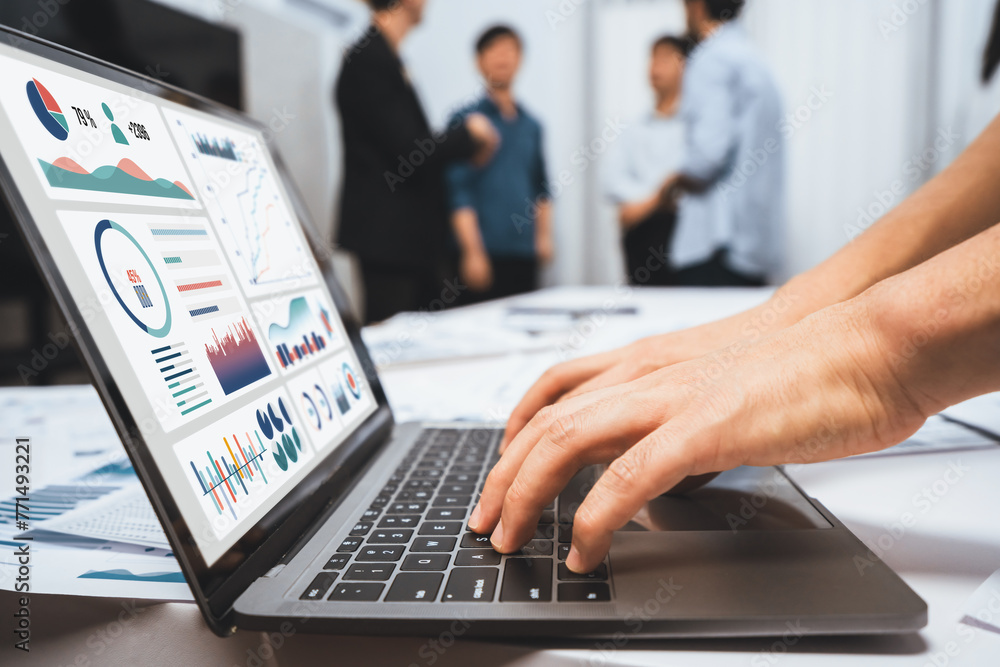 Analyst team uses BI Fintech on a laptop to analyze financial data on blurred background. Business people analyze BI dashboard for insights power into business marketing planning. Prudent - obrazy, fototapety, plakaty 