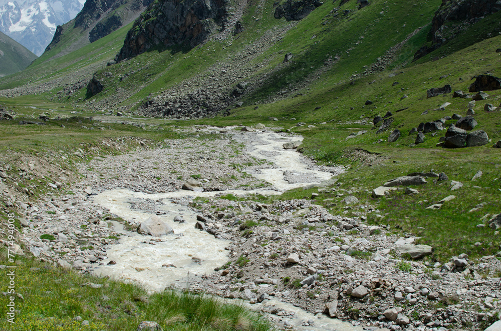 a mountain river flowing down a mountain gorge.a stormy water flow. a mountain river flowing down a mountain gorge.a stormy water flow.