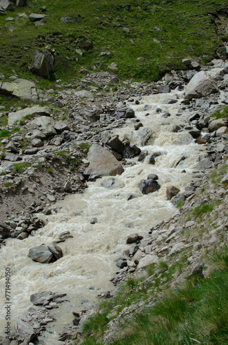 a mountain river flowing down a mountain gorge.a stormy water flow.