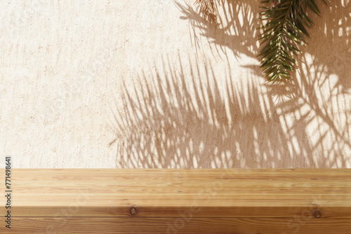 Empty wooden table over wall with palm tree shadow background. Summer picnic mock up for design and product display.